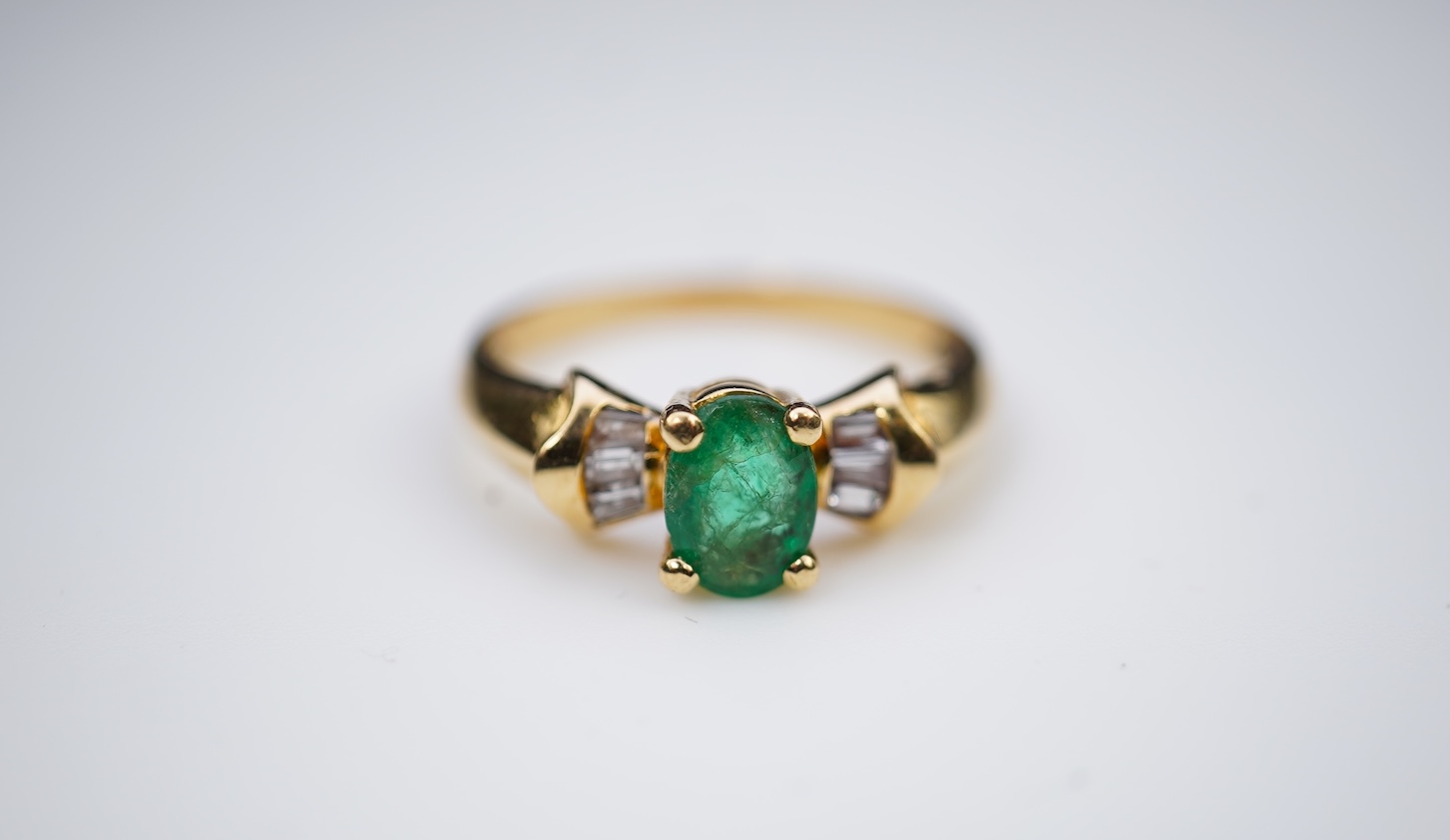An emerald and diamond ring